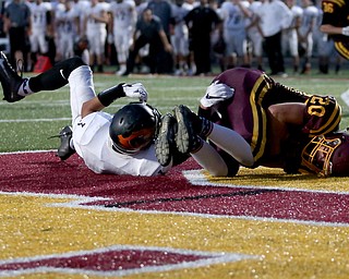 South Range Raiders tight end Josh Stear  (20) catches the pass for a touchdown as he is tackled by Springfield Local Tiger quarterback  Brandon Walters  (3) during the second quarter as Springfield local takes on South Range, Saturday, August 26, 2017, at Raider's stadium at the Rominger Sports Complex in Canfield...(Nikos Frazier | The Vindicator)..
