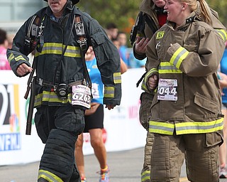 Kevin Orwick of Columbiana, William Slaypoole of West Point, Ga. and Stephanie McMasters of Wellsville complete the 2 mile portion of the 8th annual Panerathon in their turnout gear, Sunday, August 27, 2017 at the Covelli Centre in Youngstown. The firefighters ran for Firefighters in Pink...(Nikos Frazier | The Vindicator)