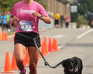 Ashley Fitch of Girard and her dog complete the 10k run during the 8th annual Panerathon, Sunday, August 27, 2017 at the Covelli Centre in Youngstown...(Nikos Frazier | The Vindicator)