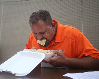 Dave Gilk of Girard stuffs his face during a pierogi eating contest at the 9th annual Polish American heritage festival, Sunday, August 27, 2017, at St. Anne's catholic Church in Austintown...(Nikos Frazier | The Vindicator)