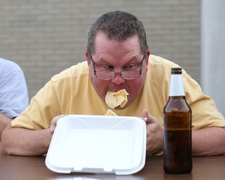 Scott Cochran of Austintown stuffs his face during a pierogi eating contest at the 9th annual Polish American heritage festival, Sunday, August 27, 2017, at St. Anne's catholic Church in Austintown...(Nikos Frazier | The Vindicator)