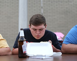 Ryan Cochran of Austintown stuffs his face during a pierogi eating contest at the 9th annual Polish American heritage festival, Sunday, August 27, 2017, at St. Anne's catholic Church in Austintown...(Nikos Frazier | The Vindicator)