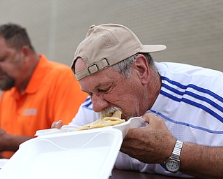 Mike Ekoniak of Canfield stuffs his face during a pierogi eating contest at the 9th annual Polish American heritage festival, Sunday, August 27, 2017, at St. Anne's catholic Church in Austintown...(Nikos Frazier | The Vindicator)