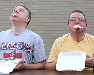 Joe Spohn of Cuyahoga Falls and Scott Cochran of Austintown stuff their faces during a pierogi eating contest at the 9th annual Polish American heritage festival, Sunday, August 27, 2017, at St. Anne's catholic Church in Austintown...(Nikos Frazier | The Vindicator)