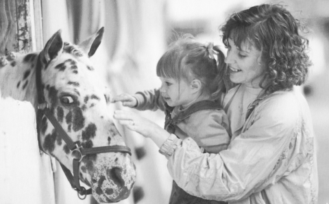 Brenda Mowery and her daughter McKenzie pet a pony at the 1992 Canfield Fair. They are from Berlin Center.