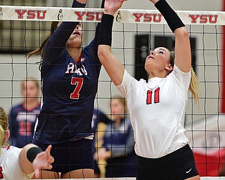 YOUNGSTWON, OHIO - AUGUST 29, 2017: Youngstown State's Heather Splinter sets the ball while Robert Morris's Maria Alfano goes for the block during their match Tuesday night at Beeghly Center. DAVID DERMER | THE VINDICATOR
