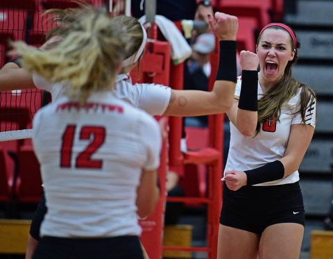 YOUNGSTWON, OHIO - AUGUST 29, 2017: Youngstown State's Sam Brown, right, pumps her fist after scoring a point with Erin Kalahar and Margaux Thompson during their match Tuesday night at Beeghly Center. DAVID DERMER | THE VINDICATOR