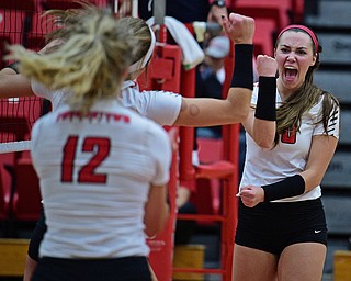 YOUNGSTWON, OHIO - AUGUST 29, 2017: Youngstown State's Sam Brown, right, pumps her fist after scoring a point with Erin Kalahar and Margaux Thompson during their match Tuesday night at Beeghly Center. DAVID DERMER | THE VINDICATOR