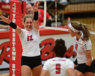 YOUNGSTWON, OHIO - AUGUST 29, 2017: Youngstown State's Margaux Thompson, left, celebrates after scoring a point with Erin Kalahar and Libbie Darling during their match Tuesday night at Beeghly Center. DAVID DERMER | THE VINDICATOR