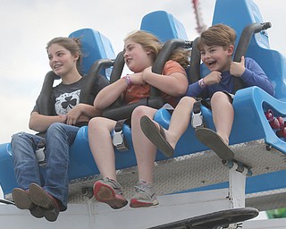    ROBERT K. YOSAY  | THE VINDICATOR..171st Canfield Fair is underway ..  as the MEGA Bounce  - Cameryn 15, Faith 11 and Fulton 8   take in the ride.. they are visiting relatives in Canfield