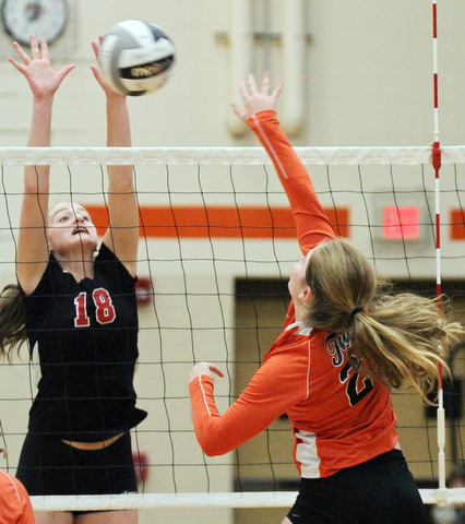 William D. Lewis The Vindicator Canfield's Grace Mangapora(18) returns a shot past Howland'sDanni Harigan(25) during 8-3--17 action at Howland.