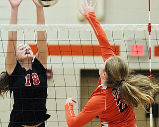 William D. Lewis The Vindicator Canfield's Grace Mangapora(18) returns a shot past Howland'sDanni Harigan(25) during 8-3--17 action at Howland.