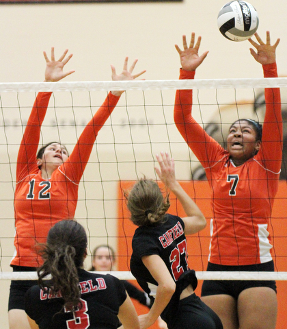 William D. Lewis The Vindicator Howland's Faith Grant(7) reurns a shot past Canfield's Lilly Ecomomus(3) and  Abbi Havrilla(27). At left is Howland's Claire Summerfield(12).