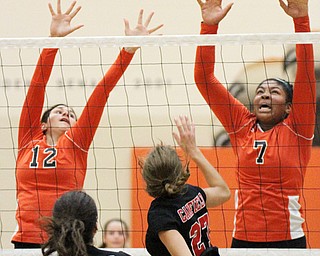 William D. Lewis The Vindicator Howland's Faith Grant(7) reurns a shot past Canfield's Lilly Ecomomus(3) and  Abbi Havrilla(27). At left is Howland's Claire Summerfield(12).