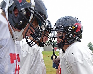 CANFIELD, OHIO - AUGUST 30, 2017: Canfield's Vinnie Fiorenza cals a play int he huddle while his offensive linemen listen during the teams practice, Wednesday afternoon at Canfield High School. DAVID DERMER | THE VINDICATOR