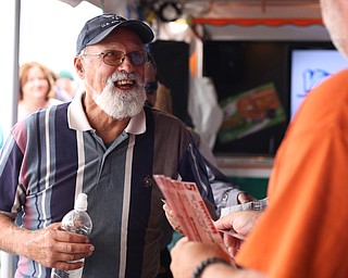 Fairgoers line up for the YSU Football ticket giveaway at the Vindicator Tent at the 171st Canfield Fair, Friday, Sept. 1, 2017, at the Canfield Fairgrounds in Canfield...(Nikos Frazier | The Vindicator)