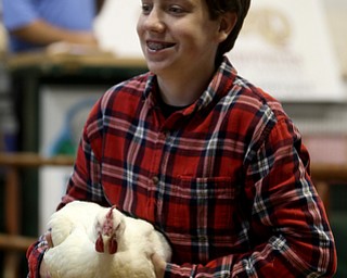 Will Bacho IV shows off his Broiler chicken on the auction stage at the 171st Canfield Fair, Friday, Sept. 1, 2017, at the Canfield Fairgrounds in Canfield...(Nikos Frazier | The Vindicator)