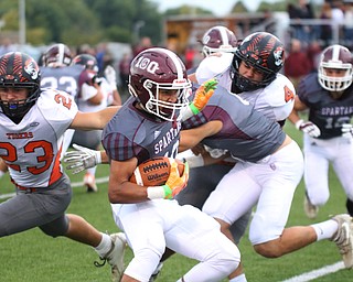             ROBERT  K. YOSAY | THE VINDICATOR...First quarter action as Boardmans #10 Maurice Pinkard  pushes by Howland #23 Garrett Deemer- Behind him is Boardman #Alex Huzica and #4 Howland  Jackson Deemer..First quarter action Howland Tigers at Boardman Stadium