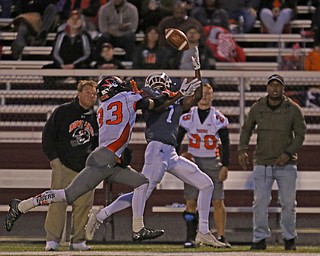             ROBERT  K. YOSAY | THE VINDICATOR..Boardmans #7 Keyshawn Colman pulls in a sidelin pass  as Howlands #33 Jonny Elliot  defends..Second Quarter action Howland Tigers at Boardman Stadium
