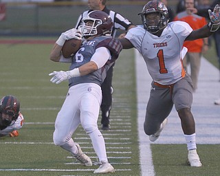             ROBERT  K. YOSAY | THE VINDICATOR..Howland Tigers at Boardman Stadium .Boardmans #6 Joe Ieraci  is tackled high by Howlands #1 Samari Dean... saving a run back..Second Quarter action Howland Tigers at Boardman Stadium