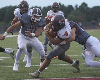             ROBERT  K. YOSAY | THE VINDICATOR..Howlads #4  Jackson Deemer spins into the endzone for  a Howland Touchdown As Boardmans #50 Steven Amstutz and tackling him is Boardman #25  Mike Melewski..Second Quarter action Howland Tigers at Boardman Stadium