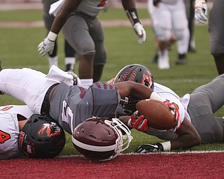            ROBERT  K. YOSAY | THE VINDICATOR..Boardmans #5Jujua Forte Crashes into the end zone scoring Boardmans first TouchdownFirst quarter action Howland Tigers at Boardman Stadium  Beside him is Howlands #4  Jackson Deemer and #5 William Hines