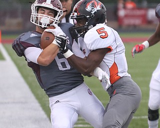             ROBERT  K. YOSAY | THE VINDICATOR..Boardmans #6  Joe Ieraci is pushed out  o bouds by #5 Howland William Hines  behind him is Boardmans #5Jujuan Forte..First quarter action Howland Tigers at Boardman Stadium