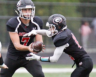 William D. Lewis The Vindicator Girard QBMark Waid(7) hands off to Morgan Clardy(16) during 1rst half action at Girard 9-1-17.