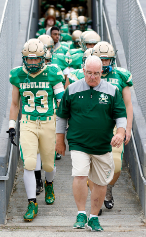 MICHAEL G TAYLOR | THE VINDICATOR-9-01-17 FOOTBALL Youngstown East Golden Bears vs Ursuline Irish at Rayen Stadium, Youngstown, OH    Head Coach Larry Kempe brings his team through the tunnel