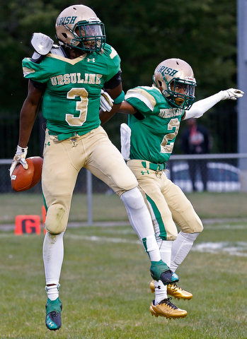 MICHAEL G TAYLOR | THE VINDICATOR-9-01-17 FOOTBALL Youngstown East Golden Bears vs Ursuline Irish at Rayen Stadium, Youngstown, OH    1st qtr., after his TD reception, Ursuline's #3 James Phillips celebrates with his teammate #2 Julian Johnson.