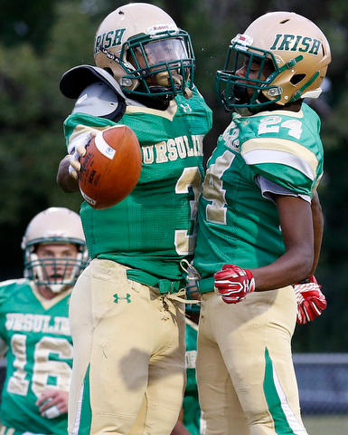 MICHAEL G TAYLOR | THE VINDICATOR-9-01-17 FOOTBALL Youngstown East Panthers vs Ursuline Irish at Rayen Stadium, Youngstown, OH    1st qtr., after his TD reception, Ursuline's #3 Jame Phillips celebrates with his teammate #24 Robbie Sullivan