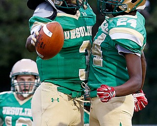 MICHAEL G TAYLOR | THE VINDICATOR-9-01-17 FOOTBALL Youngstown East Panthers vs Ursuline Irish at Rayen Stadium, Youngstown, OH    1st qtr., after his TD reception, Ursuline's #3 Jame Phillips celebrates with his teammate #24 Robbie Sullivan
