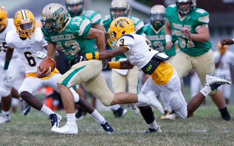 MICHAEL G TAYLOR | THE VINDICATOR-9-01-17 FOOTBALL Youngstown East Golden Bears vs Ursuline Irish at Rayen Stadium, Youngstown, OH    1st qtr., Ursuline's qb #13 Jared Fabry runs for the 1st as East'#3 Greg Lincoln makes the tackle.