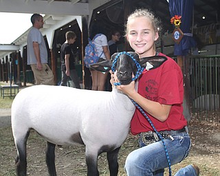 Abigail Gay(14) poses for a portrait with her lamb, Jay at the 171st Canfield Fair, Thursday, August 31, 2017, at the Canfield Fairgrounds in Canfield. Abigail is donating her lamb to the Junior Fair New Building Campaign...(Nikos Frazier | The Vindicator)