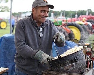 Terry Hacon lifts a fresh kettle of popcorn off the shaker at the 171st Canfield Fair, Saturday, Sept. 2, 2017, at the Canfield Fairgrounds in Canfield...(Nikos Frazier | The Vindicator)