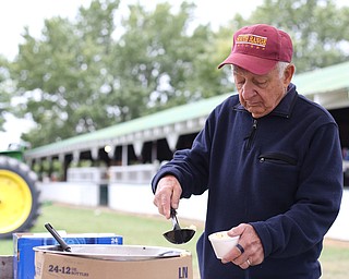 Joe Perkins of Poland scoops some fresh popped popcorn at the 171st Canfield Fair, Saturday, Sept. 2, 2017, at the Canfield Fairgrounds in Canfield...(Nikos Frazier | The Vindicator)