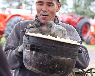 Terry Hacon lifts a freshly popped kettle of popcorn off of the shaker at the 171st Canfield Fair, Saturday, Sept. 2, 2017, at the Canfield Fairgrounds in Canfield...(Nikos Frazier | The Vindicator)