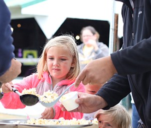 Will Enders(right) of Aliquippa, Pa. scoops popcorn for Lily(6)(left) and Emma(2)(center) at the 171st Canfield Fair, Saturday, Sept. 2, 2017, at the Canfield Fairgrounds in Canfield...(Nikos Frazier | The Vindicator)