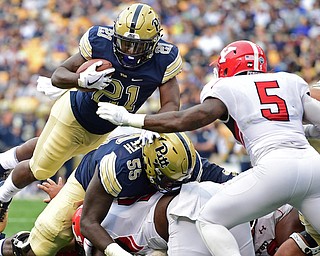 PITTSBURGH, PENNSYLVANIA - SEPTEMBER 2, 2017:  Pittsburgh's Malik Henderson, left, launches himself over the goal line to score a touchdown before being hit by Youngstown State's Lee Wright during the first half of their game Saturday afternoon at Heinz Field. Pitt won 28-21 in overtime. (DAVID DERMER | THE VINDICATOR)