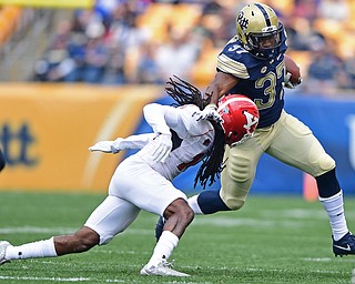 PITTSBURGH, PENNSYLVANIA - SEPTEMBER 2, 2017:  Pittsburgh's Qadree Ollison runs the football before being hit by Youngstown State's Solomon Warfield during the first half of their game Saturday afternoon at Heinz Field. Pitt won 28-21 in overtime. (DAVID DERMER | THE VINDICATOR)