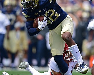 PITTSBURGH, PENNSYLVANIA - SEPTEMBER 2, 2017:  Pittsburgh's Darrin Hall runs through the arm tackle of Youngstown State's Billy Nicoe Hurst during the first half of their game Saturday afternoon at Heinz Field. Pitt won 28-21 in overtime. (DAVID DERMER | THE VINDICATOR)