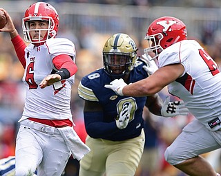 PITTSBURGH, PENNSYLVANIA - SEPTEMBER 2, 2017:  Youngstown State's Hunter Wells throws a pass while picking up a block from Justin Spencer on Pittsburgh's Dewayne Pickett during the first half of their game Saturday afternoon at Heinz Field. Pitt won 28-21 in overtime. (DAVID DERMER | THE VINDICATOR)