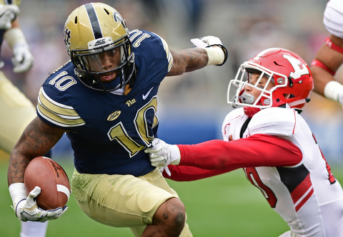 PITTSBURGH, PENNSYLVANIA - SEPTEMBER 2, 2017:  Pittsburgh's Quadree Henderson runs with the ball while Youngstown State's Kyle Hegedus during the first half of their game Saturday afternoon at Heinz Field. Pitt won 28-21 in overtime. (DAVID DERMER | THE VINDICATOR)