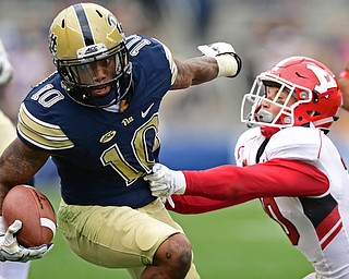 PITTSBURGH, PENNSYLVANIA - SEPTEMBER 2, 2017:  Pittsburgh's Quadree Henderson runs with the ball while Youngstown State's Kyle Hegedus during the first half of their game Saturday afternoon at Heinz Field. Pitt won 28-21 in overtime. (DAVID DERMER | THE VINDICATOR)