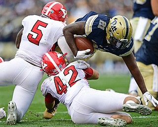 PITTSBURGH, PENNSYLVANIA - SEPTEMBER 2, 2017:  Pittsburgh's A.J. Davis runs the ball for a first down while being hit by Youngstown State's Lee Wright and Armand Dellovade during the first half of their game Saturday afternoon at Heinz Field. Pitt won 28-21 in overtime. (DAVID DERMER | THE VINDICATOR)