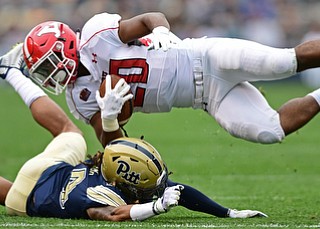 PITTSBURGH, PENNSYLVANIA - SEPTEMBER 2, 2017:  Youngstown State's Christian Turner spins through the air after being hit by Pittsburgh's Avonte Maddox during the first half of their game Saturday afternoon at Heinz Field. Pitt won 28-21 in overtime. (DAVID DERMER | THE VINDICATOR)