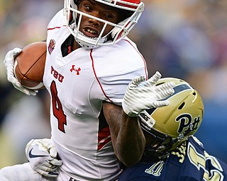 PITTSBURGH, PENNSYLVANIA - SEPTEMBER 2, 2017:  Youngstown State's Damoun Patterson tuns upfield while being hut by Pittsburgh's Dane Jackson during the second half of their game Saturday afternoon at Heinz Field. Pitt won 28-21 in overtime. (DAVID DERMER | THE VINDICATOR)