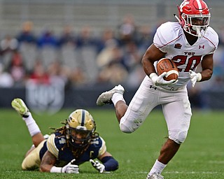 PITTSBURGH, PENNSYLVANIA - SEPTEMBER 2, 2017:  Youngstown State's Christian Turner runs upfield after slipping out of a tackle from Pittsburgh's Avonte Maddox during the second half of their game Saturday afternoon at Heinz Field. Pitt won 28-21 in overtime. (DAVID DERMER | THE VINDICATOR)