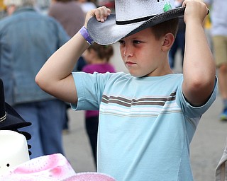 Nathan Hoversten(10) of Hartville, tries on a cowboy hat at Altmeyer's Western Wear at the 171st Canfield Fair, Sunday, Sept. 3, 2017, at the Canfield Fairgrounds in Canfield...(Nikos Frazier | The Vindicator)
