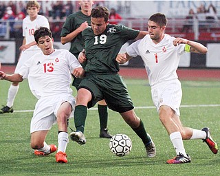 William D. Leiws The vindicator  Ursuline's AJ Santana(19) keeps the ball from  Mooney'sNick Jadue(13) and Nate Jones(1)during 9-5-17 action at YSU.